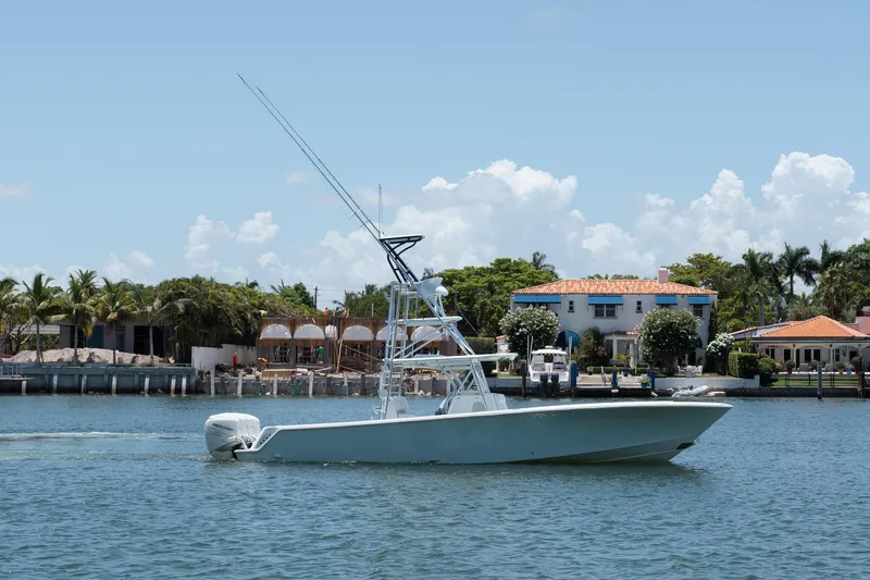 Slide: The Image of 2017 SeaVee 390Z boat cruising on a sunny day near waterfront homes. - 4