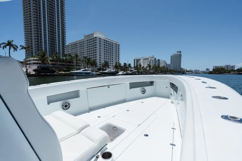 Slide: The Image of 2017 SeaVee 390Z boat on water, city skyline in background, clear blue sky. - 8