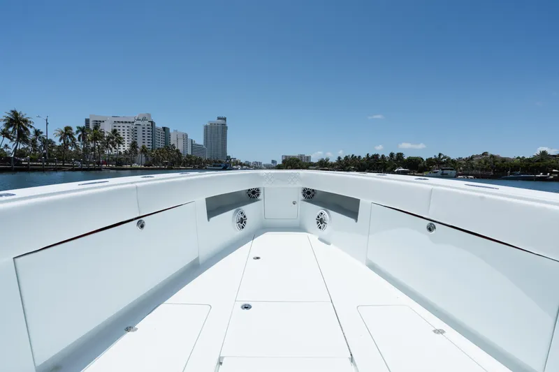 Slide: The Image of 2017 SeaVee 390Z boat deck with city skyline and palm trees in the background. - 9
