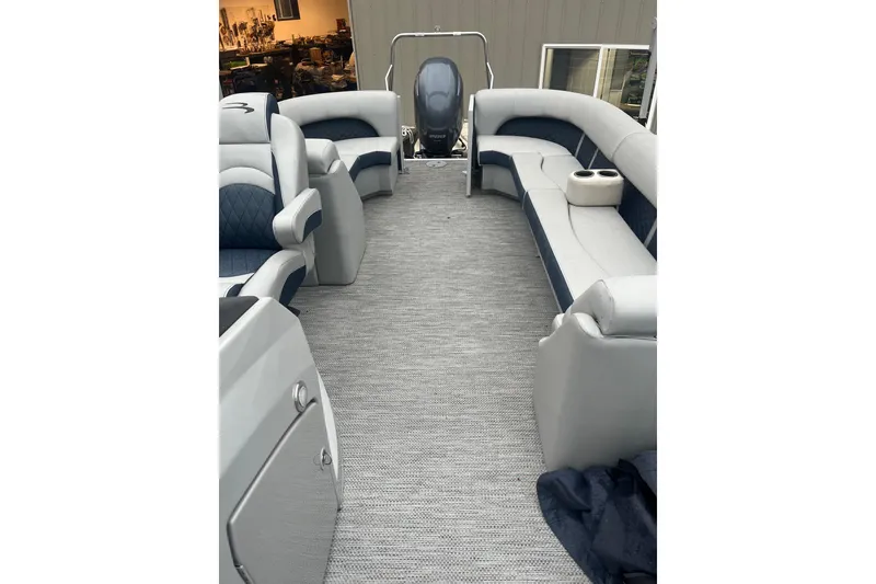 Slide: The Image of 2022 Bennington 25 LSR pontoon boat interior with plush seating and modern design. - 5