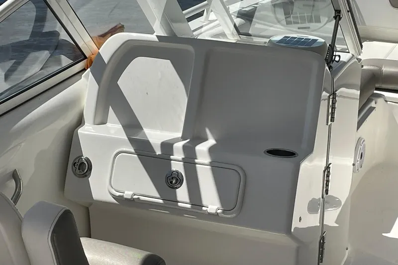 Slide: The Image of Interior of 2022 World Cat 255 DC boat, featuring seating and storage compartments. - 6