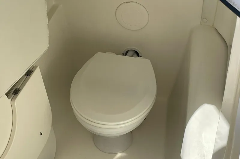 Slide: The Image of 2022 World Cat 255 DC boat interior with compact marine toilet. - 7