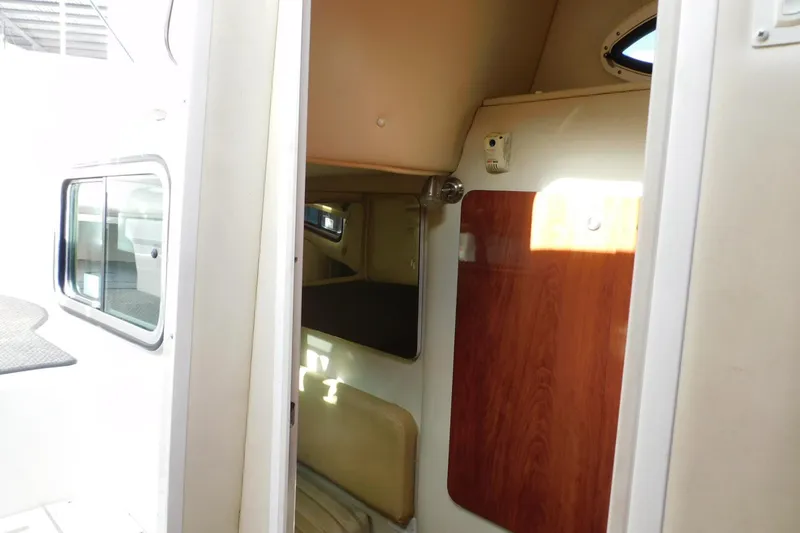 Slide: The Image of Interior view of 2006 Monterey 302 Cruiser cabin with seating and wood paneling. - 11