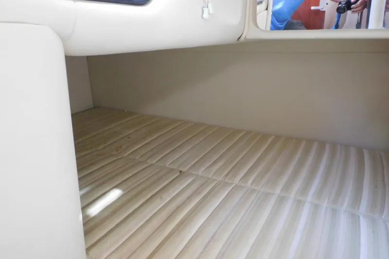 Slide: The Image of 2006 Monterey 302 Cruiser cabin interior with striped mattress. - 12