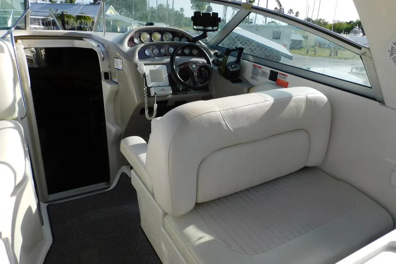 Slide: The Image of Interior of a 2006 Monterey 302 Cruiser boat with steering console and seating. - 18