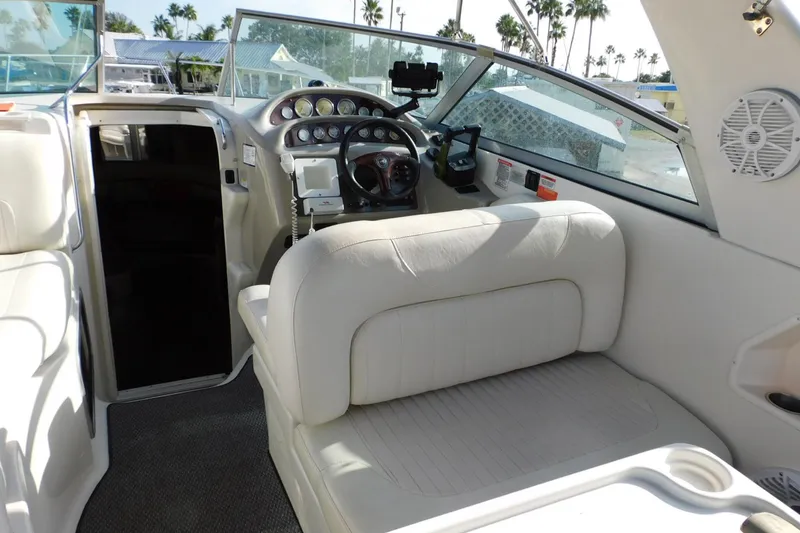 Slide: The Image of Interior of 2006 Monterey 302 Cruiser boat with white seating and control panel. - 19