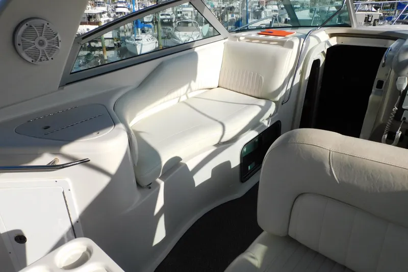 Slide: The Image of Interior of a 2006 Monterey 302 Cruiser with white seating and marina view. - 20