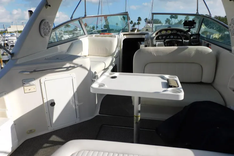 Slide: The Image of Interior of a 2006 Monterey 302 Cruiser boat with seating and table. - 21