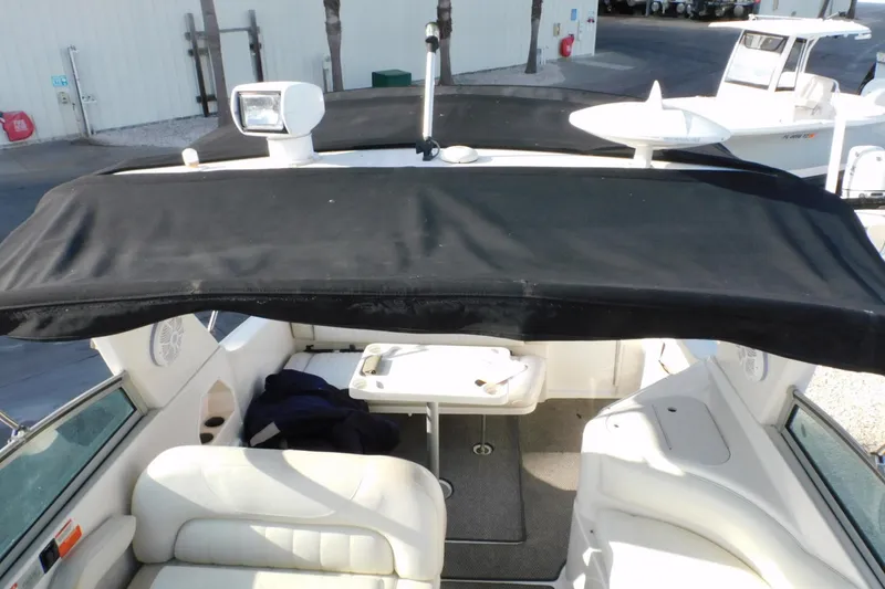 Slide: The Image of 2006 Monterey 302 Cruiser interior with black canopy and white seating. - 26