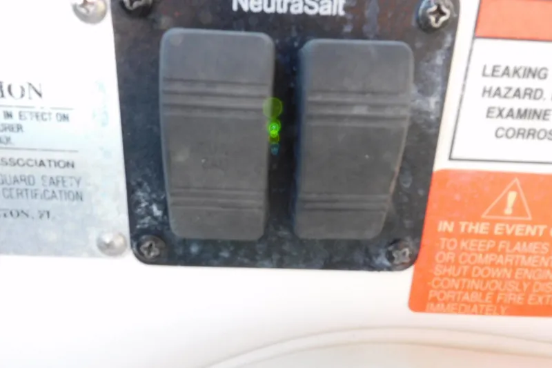 Slide: The Image of Control panel of a 2006 Monterey 302 Cruiser boat with safety warnings. - 27