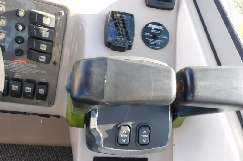 Slide: The Image of Control panel of a 2006 Monterey 302 Cruiser boat with trim buttons and switches. - 28