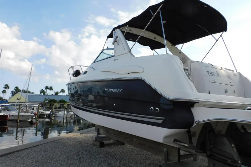 Slide: The Image of 2006 Monterey 302 Cruiser boat docked at marina under blue sky. - 31