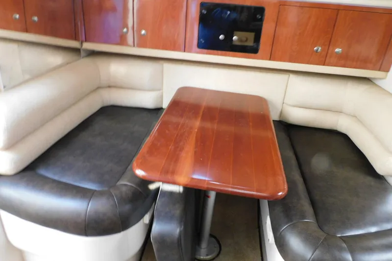Slide: The Image of 2006 Monterey 302 Cruiser interior with wooden table and cushioned seating. - 4