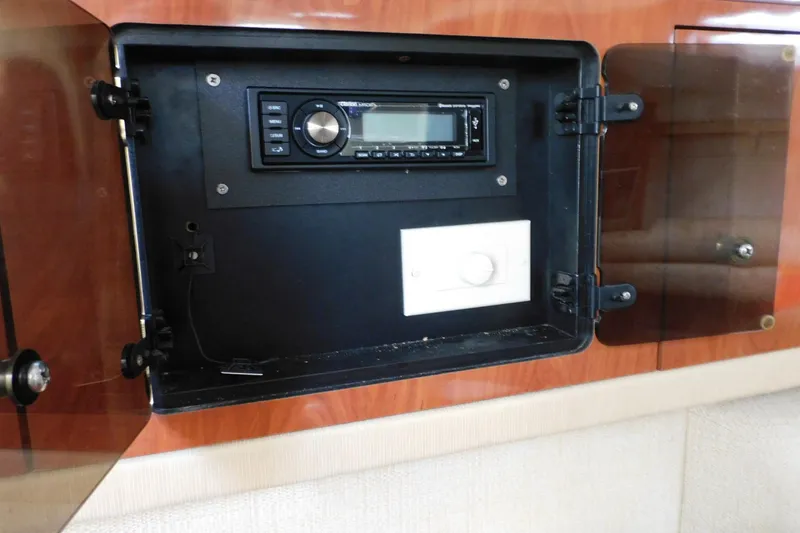 Slide: The Image of 2006 Monterey 302 Cruiser stereo system in wooden cabinet with glass doors. - 5