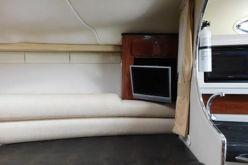 Slide: The Image of Interior of 2006 Monterey 302 Cruiser with TV, sofa, and fire extinguisher. - 7