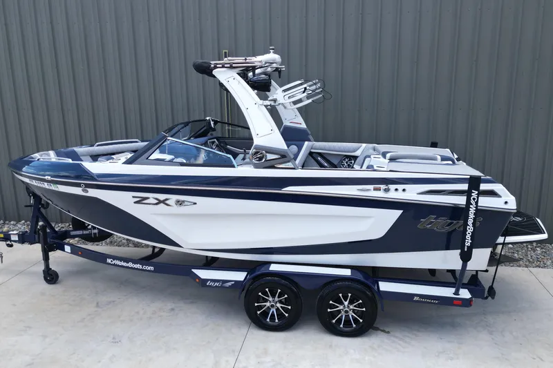 Slide: The Image of 2019 Tigé ZX1 boat on trailer, sleek design, parked outdoors. - 3