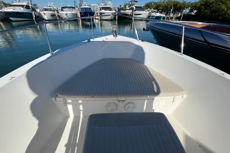 Slide: The Image of 2004 Hydra-Sports 212 CC boat interior with seating, docked at marina. - 11