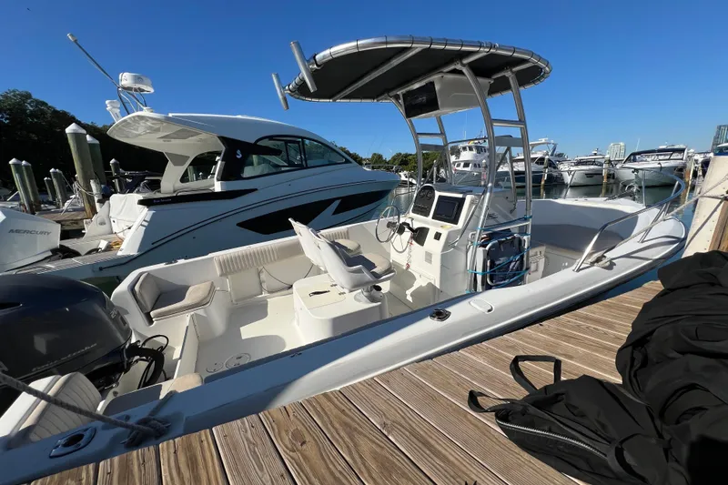 Slide: The Image of 2004 Hydra-Sports 212 CC boat docked at marina, featuring center console and seating. - 12