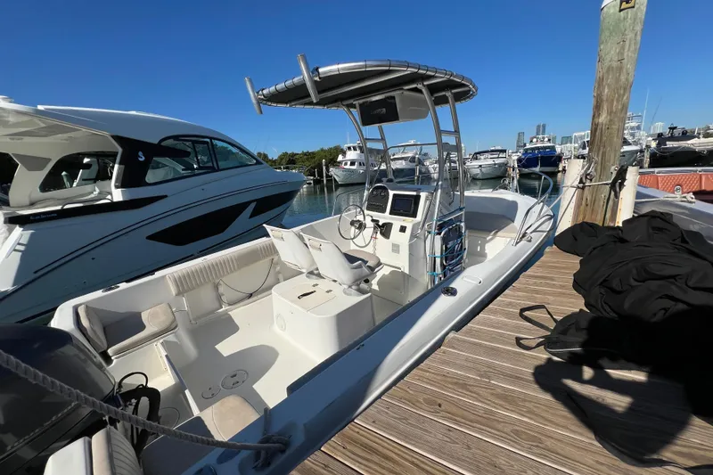 Slide: The Image of 2004 Hydra-Sports 212 CC boat docked at marina, clear blue sky background. - 14