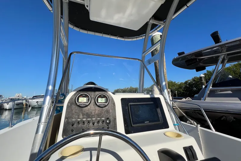 Slide: The Image of 2004 Hydra-Sports 212 CC boat dashboard with gauges and navigation screen at marina. - 15