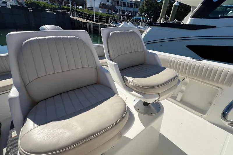 Slide: The Image of 2004 Hydra-Sports 212 CC boat with two cushioned seats, docked in a marina. - 17