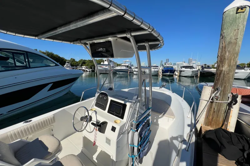 Slide: The Image of 2004 Hydra-Sports 212 CC boat docked at marina with clear blue sky. - 23