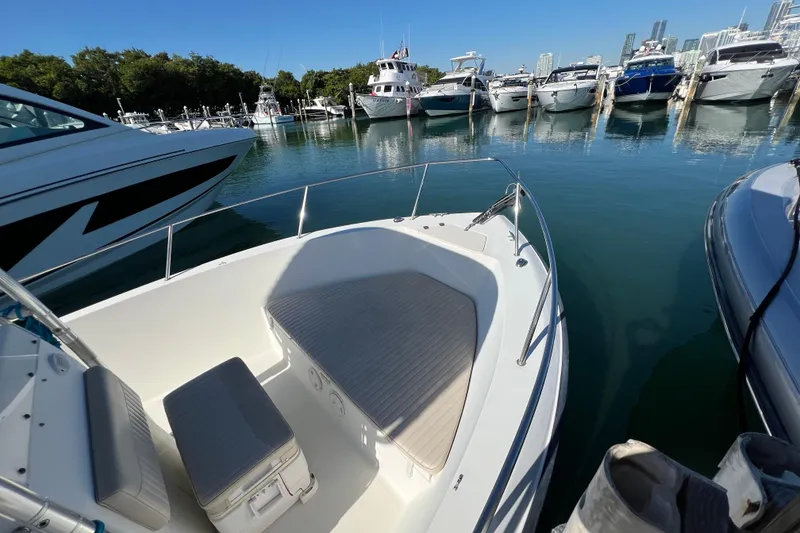 Slide: The Image of 2004 Hydra-Sports 212 CC boat docked in a marina with other vessels. - 26