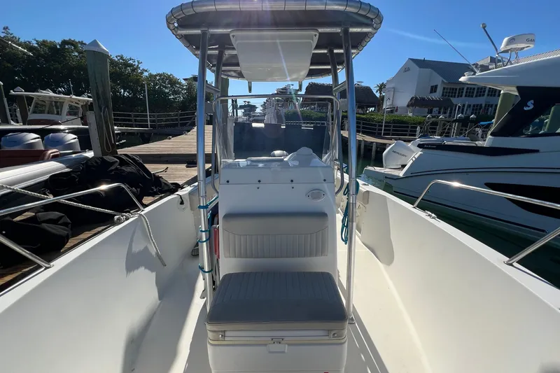Slide: The Image of 2004 Hydra-Sports 212 CC boat docked, featuring center console and seating, under clear blue sky. - 30