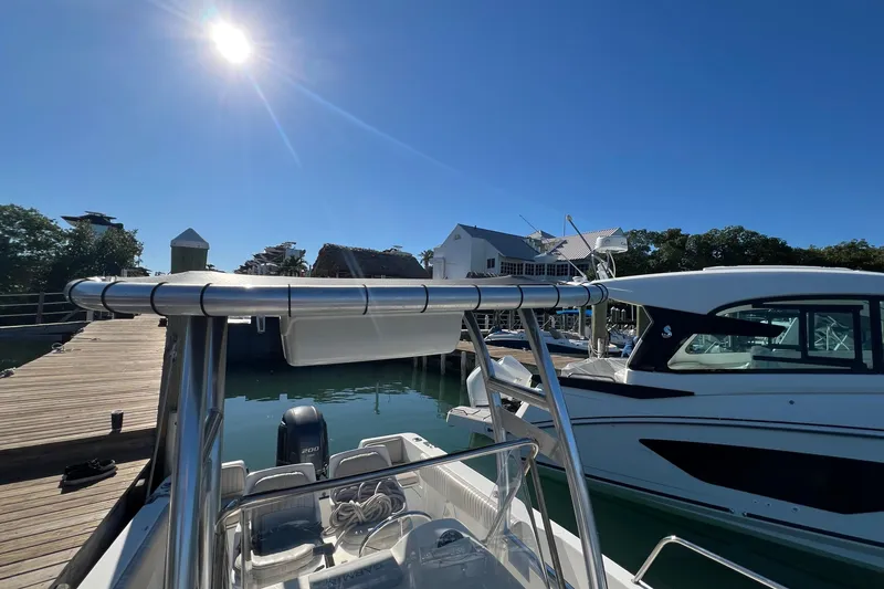 Slide: The Image of 2004 Hydra-Sports 212 CC boat docked under clear blue sky. - 37