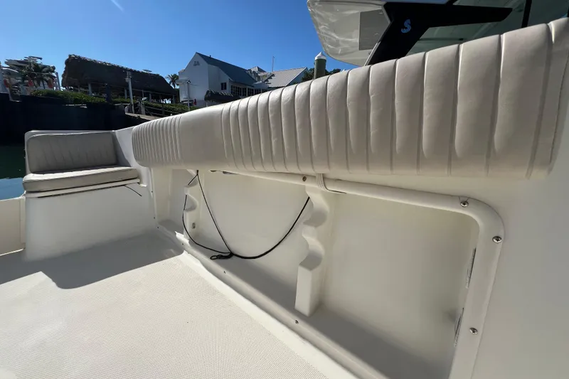Slide: The Image of 2004 Hydra-Sports 212 CC boat interior with cushioned seating and sunny marina backdrop. - 39