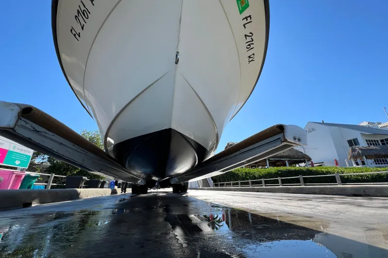 Slide: The Image of 2004 Hydra-Sports 212 CC boat on trailer, viewed from below, with clear blue sky. - 41