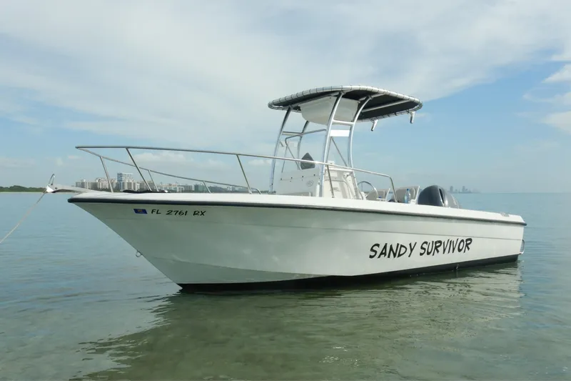 Slide: The Image of 2004 Hydra-Sports 212 CC boat named "Sandy Survivor" on calm water. - 6
