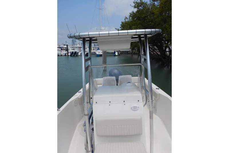 Slide: The Image of 2004 Hydra-Sports 212 CC boat docked in a marina, featuring a T-top and center console. - 7