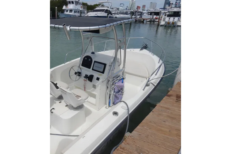 Slide: The Image of 2004 Hydra-Sports 212 CC boat docked, featuring a center console and T-top canopy. - 8