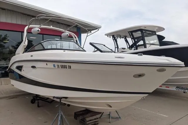 The Image of 2018 Sea Ray SLX-W 230 boat displayed at a dealership. - 0