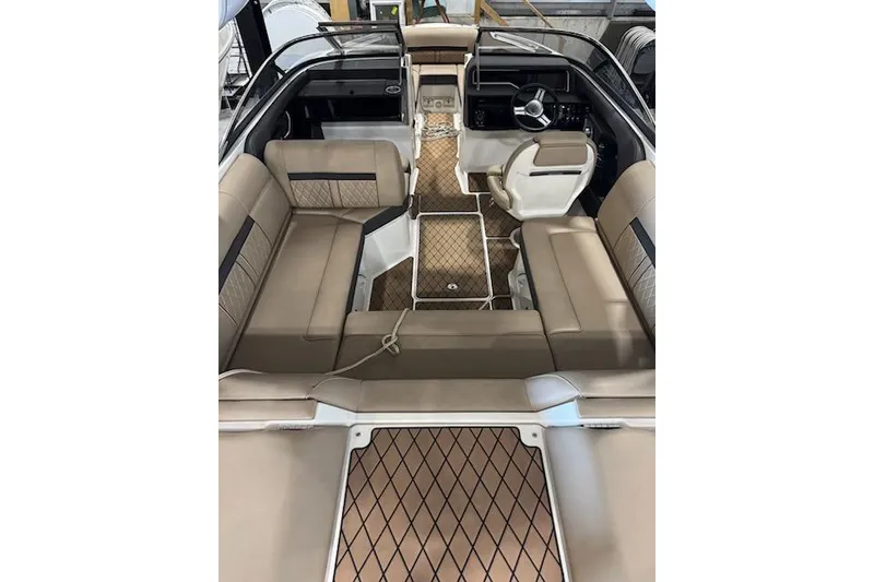Slide: The Image of 2018 Sea Ray SLX-W 230 boat interior with beige seating and modern dashboard. - 18