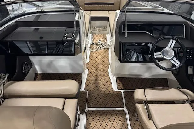 Slide: The Image of 2018 Sea Ray SLX-W 230 boat interior with beige seating and modern dashboard. - 19