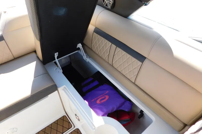 Slide: The Image of 2018 Sea Ray SLX-W 230 boat interior storage with life jacket. - 24
