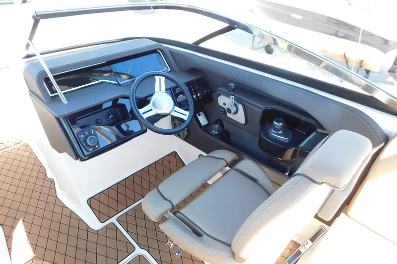 Slide: The Image of 2018 Sea Ray SLX-W 230 boat cockpit with modern steering and controls. - 25