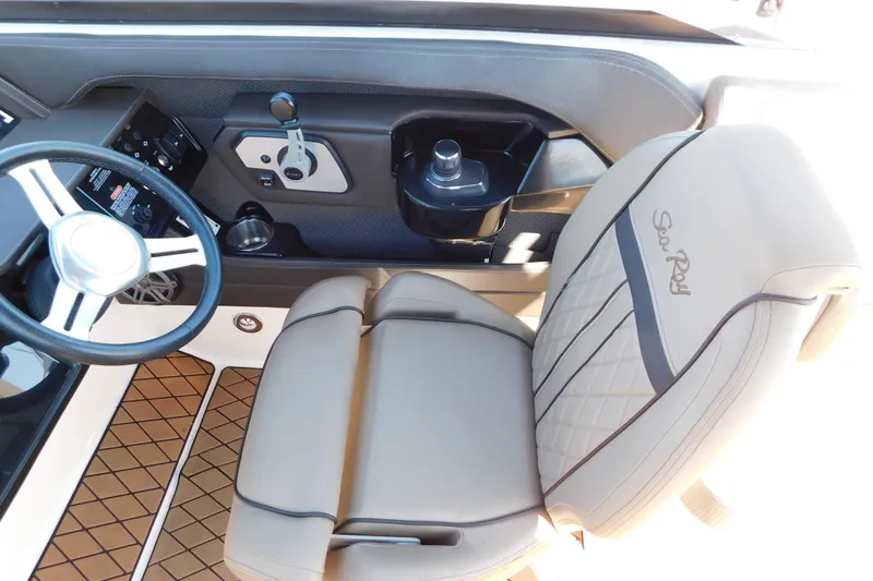 Slide: The Image of 2018 Sea Ray SLX-W 230 boat interior with steering wheel and branded seat. - 27