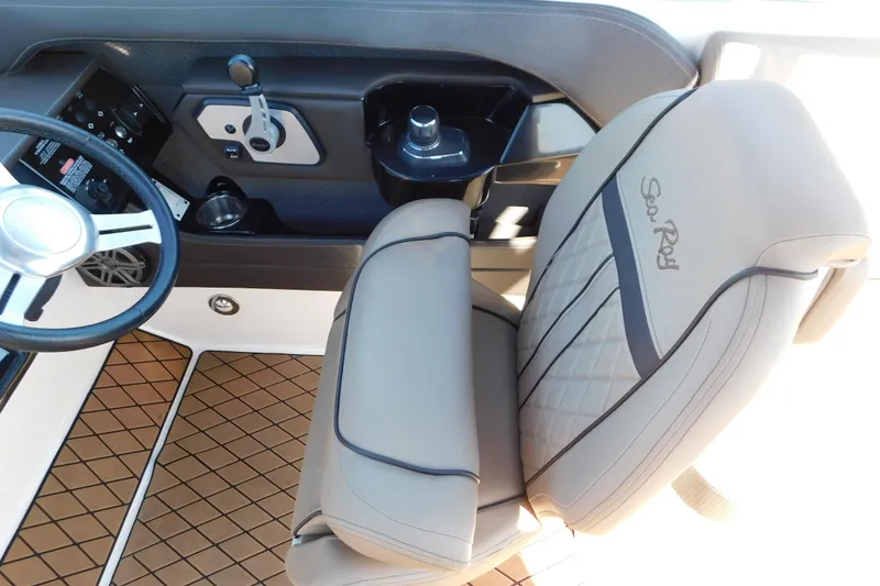 Slide: The Image of 2018 Sea Ray SLX-W 230 interior with steering wheel and branded seat. - 28
