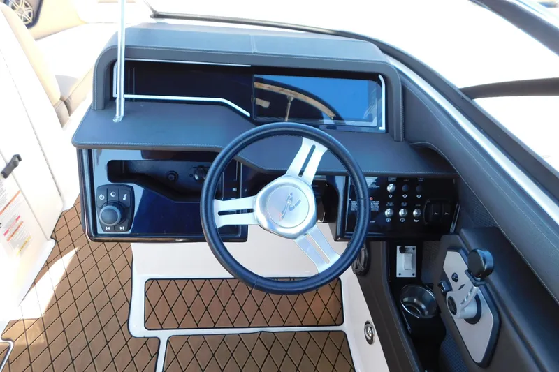 Slide: The Image of 2018 Sea Ray SLX-W 230 boat dashboard with steering wheel and control panel. - 29
