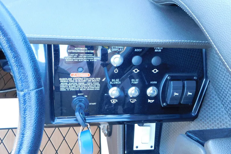 Slide: The Image of Control panel of a 2018 Sea Ray SLX-W 230 boat with various switches and warnings. - 31