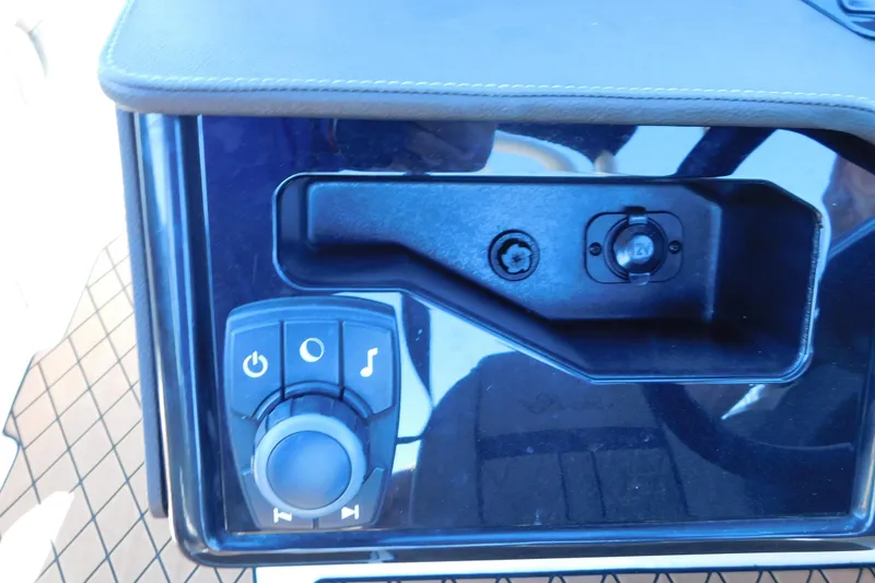 Slide: The Image of Control panel of 2018 Sea Ray SLX-W 230 boat with audio and power buttons. - 32