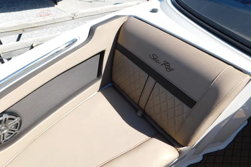 Slide: The Image of 2018 Sea Ray SLX-W 230 boat interior with beige seating and speaker detail. - 34