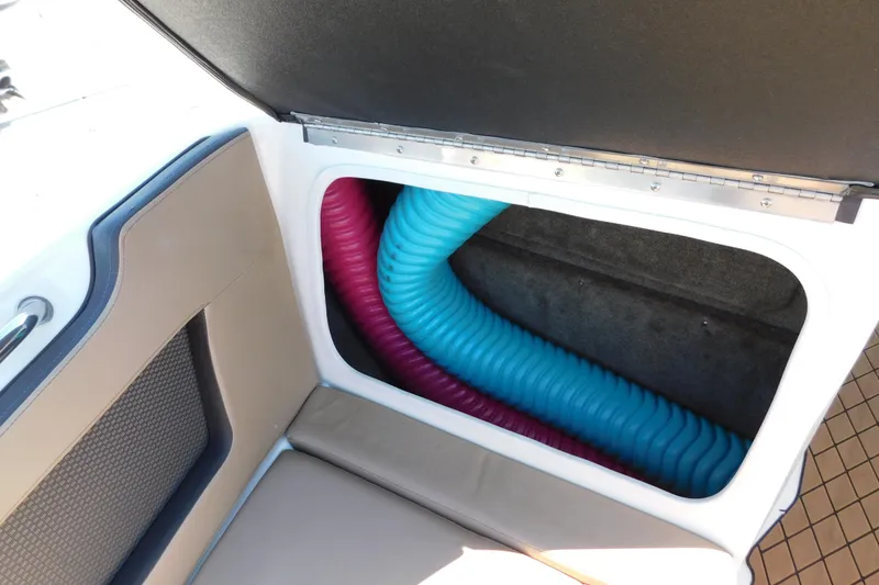 Slide: The Image of Storage compartment of 2018 Sea Ray SLX-W 230 boat with colorful hoses. - 35
