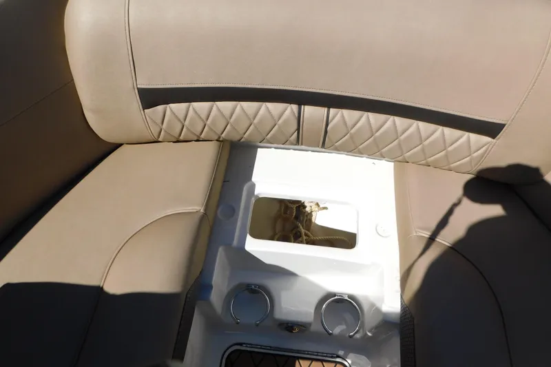 Slide: The Image of 2018 Sea Ray SLX-W 230 boat interior with beige quilted seating and storage compartment. - 39
