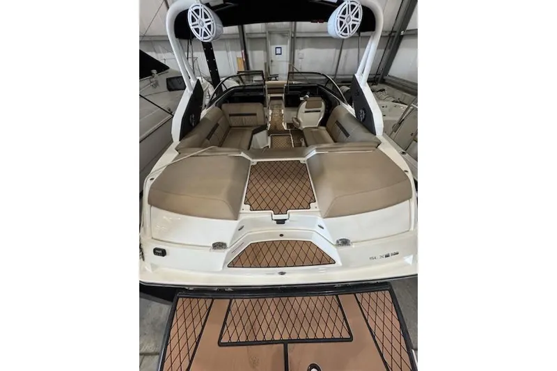 Slide: The Image of 2018 Sea Ray SLX-W 230 boat interior with tan seating and teak flooring. - 4