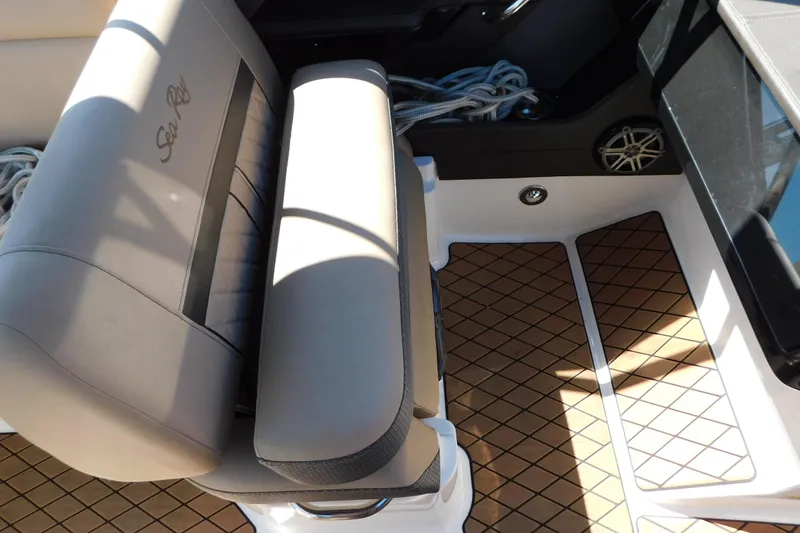 Slide: The Image of 2018 Sea Ray SLX-W 230 boat interior with cushioned seating and patterned flooring. - 43