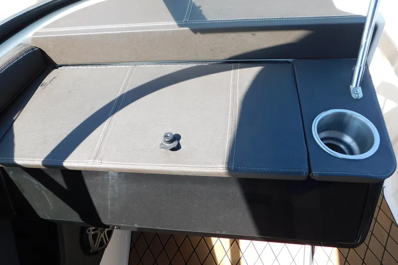 Slide: The Image of 2018 Sea Ray SLX-W 230 boat interior with cup holder and seating area. - 46
